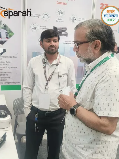 A detailed technical discussion with an interested visitor at ICSMS 2025. My team is equipped to answer any question about my advanced surveillance systems.