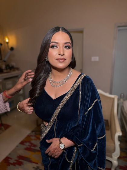 A candid moment of getting ready. This shot captures the beautiful side profile of her bronze glam makeup, with a focus on sculpted cheeks and defined eyes.