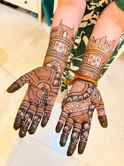 A beautiful bridal design featuring the Mumbai skyline on both arms. This is a perfect example of how we can weave your personal story and important places into your mehendi.
