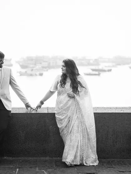 A black and white portrait by the Mumbai docks. The industrial backdrop provides a unique and moody setting for a love story.