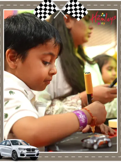A young racer is deep in concentration as he customizes his car at our Mini Racers event. These creative activities are designed to build confidence and spark curiosity in a fun setting.