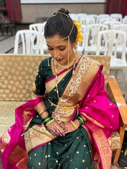 A quiet moment before the ceremony. The bride looks serene and beautiful in her full Peshwai attire.