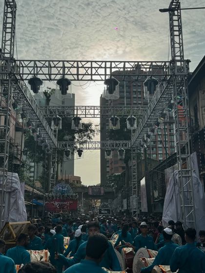 This daytime shot shows the sheer scale of the truss structure I build for Aagman ceremonies like this one for Kalachowkicha Mahaganpati. The setup is engineered for safety and impact, framing the street and preparing for the nighttime light show.
