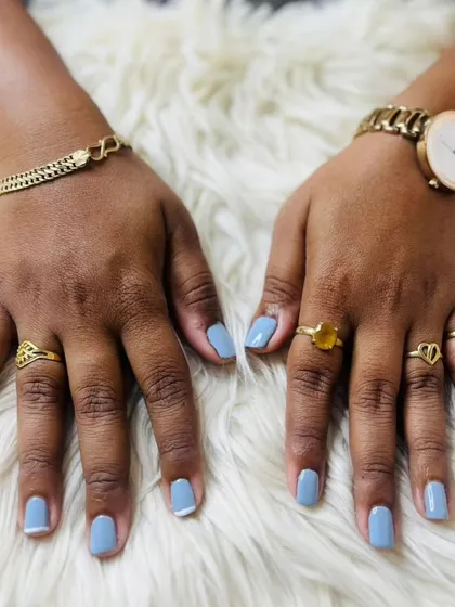 A full view of the dusty blue manicure, showing how stylish a simple color can be on well-maintained natural nails.