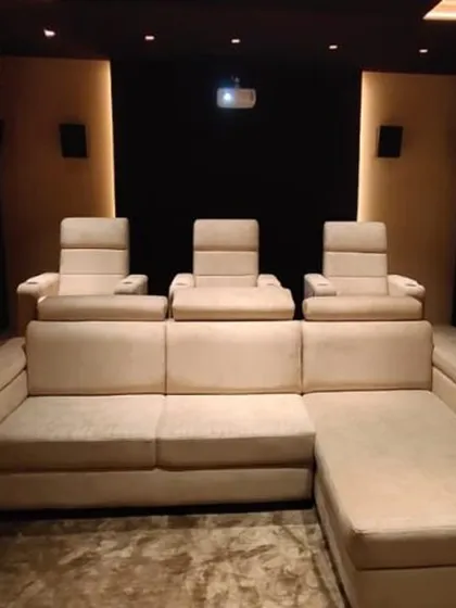 A closer look at the seating arrangement in this custom media room. The combination of a large sofa and individual recliners provides a versatile and comfortable environment for long movie marathons or casual viewing.