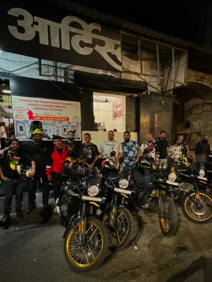 A group of Royal Enfield riders posing with their bikes after a satisfying meal at Bademiya. Good food and good company on the open road.