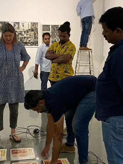 The team laying out works on the floor to plan the arrangement for 'Southern Stars'.