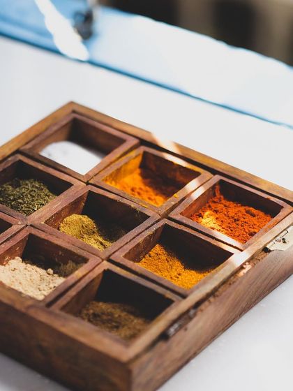A traditional Indian spice box, or masala dabba. Understanding spices is fundamental to mastering Indian cuisine, a key part of our curriculum.