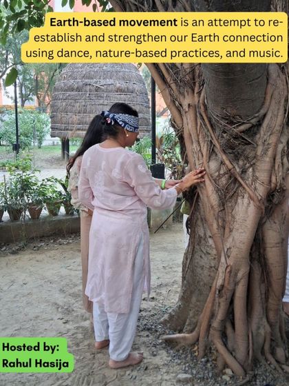 A participant connects with a tree while blindfolded during the Earth-Based Movement workshop. This practice helps strengthen our connection to nature through sensory exploration and dance.
