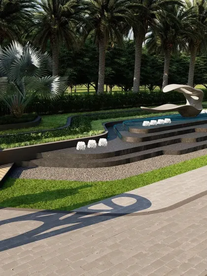 A close-up of the stepped water cascade and abstract sculpture. The design uses dark stone and bubbling fountains to create a powerful and contemporary focal point for the commercial space.