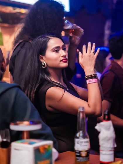 A guest enjoying the music from the side of the dance floor.