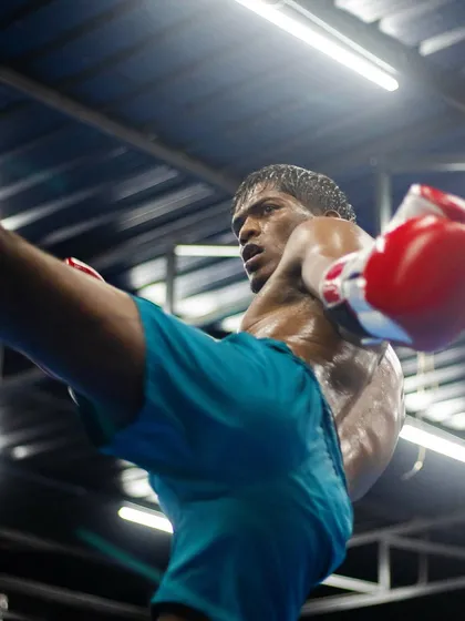 Power and precision in a single motion. One of our athletes executes a perfect high kick during a Muay Thai training session. We drill techniques like this until they become second nature.