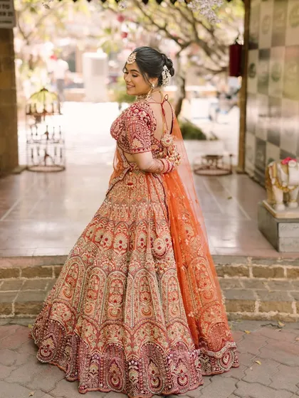 A side profile showing the elegant bridal bun and the beautiful fit of her blouse. Every detail is considered to create a perfect overall look.