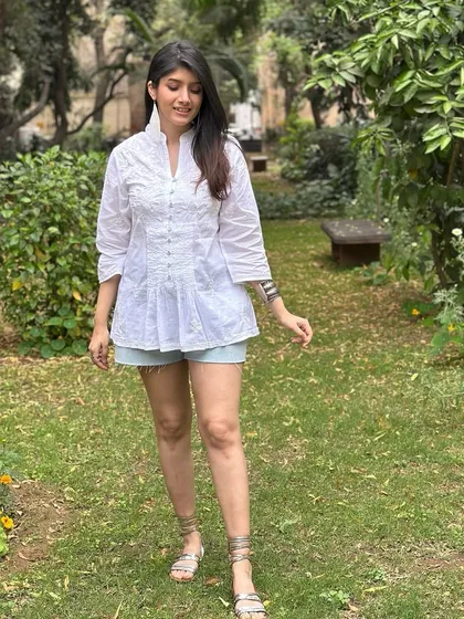 A white Chikankari kurti paired with denim shorts is a modern and fun take on ethnic wear. It's a perfect outfit for a relaxed, sunny celebration where you want to be comfortable yet stylish.