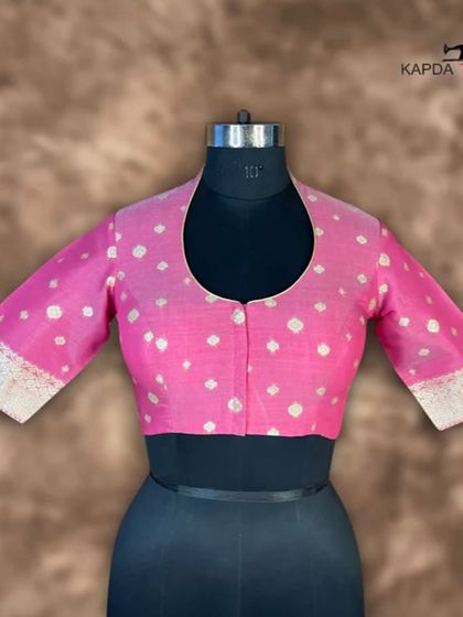 A front view of the Banarasi pink brocade blouse. The U-neck and front button closure offer a clean, sophisticated look, while the rich fabric makes it perfect for special occasions.