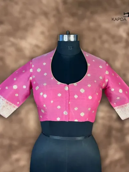 A front view of the Banarasi pink brocade blouse. The U-neck and front button closure offer a clean, sophisticated look, while the rich fabric makes it perfect for special occasions.