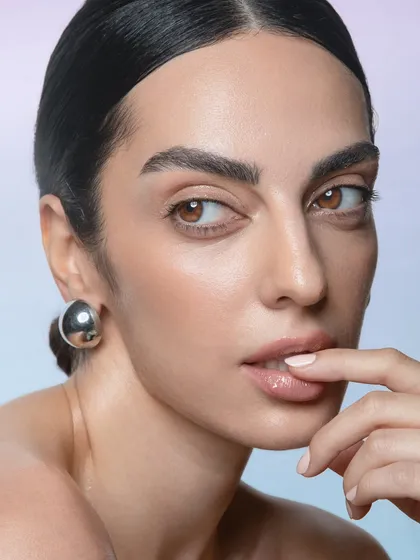 This close-up highlights the subtle details of the makeup, from the light sheen on the eyelids to the perfectly blended skin. It's a testament to creating a polished look that still feels natural.