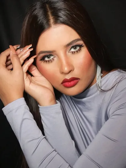 A portfolio-ready look with a bold red lip and defined eyes, showcasing the kind of work students can create for models.