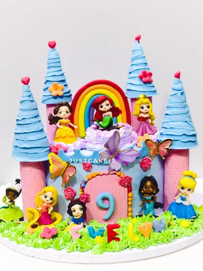 A magical Disney princesses castle cake, complete with multiple towers and a whole court of edible princess figurines.