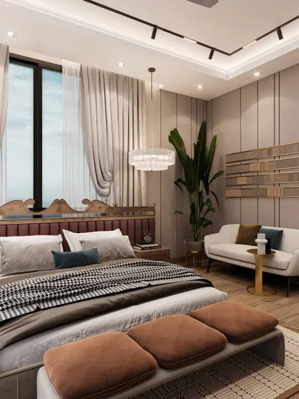 A view of the seating area in the bedroom, featuring a small white sofa and layered wall paneling. The design is curated to elevate modern living into a luxurious experience.