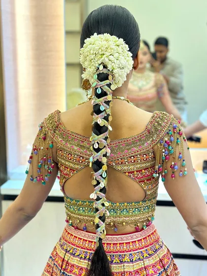 A closer view of the intricate details in this Teej braid, with a beautiful gajra of fresh jasmine flowers at the base.