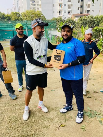 A player from the TUG Blaster team receives his winner's prize from the coach.