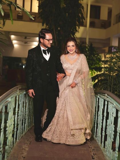 A beautiful couple shot from their reception. The bride looks elegant in her beige lehenga with soft makeup and hair.