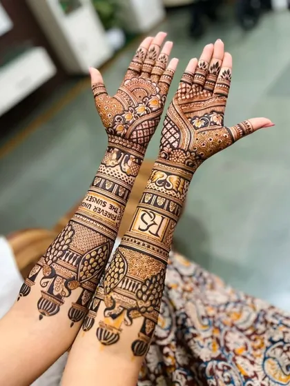 A personalized mehndi design with the initials 'RS' and the phrase 'Forever Until The Sunset' written on the arms.