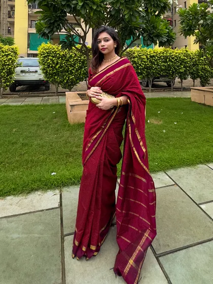 A full-length shot showing the beautiful fall of the saree's pallu. It's a very regal and graceful look.