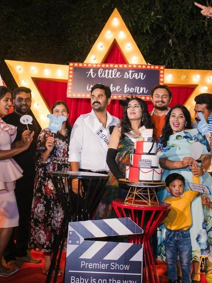 A moment of pure joy and celebration with family and friends. The themed backdrop and props bring everyone together for fun photos and lasting memories at this movie premiere baby shower.