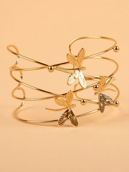 A three-quarter view of the delicate dragonfly cuff.