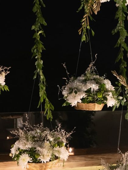 A closer look at the elegant floral decor for the engagement. I use hanging baskets and fresh white flowers to create a dreamy, sophisticated ambiance for your special day.