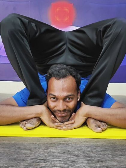 A practitioner rests in Sleeping Tortoise Pose, showcasing the peaceful side of advanced flexibility.