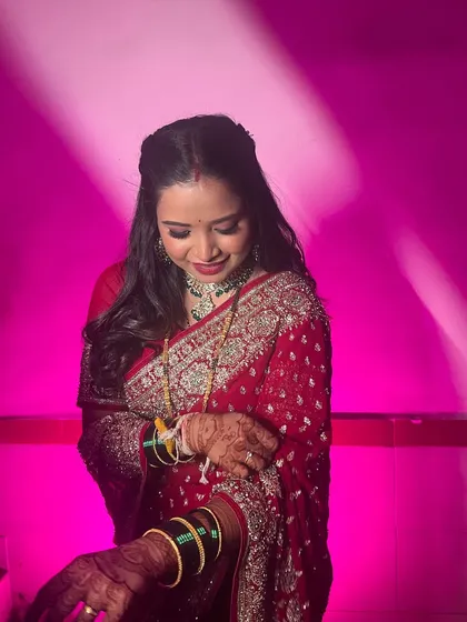 A candid moment showing the intricate work on the saree and the soft waves in her hair.