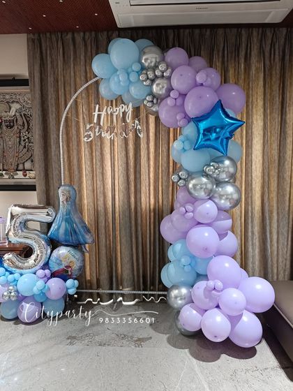 Another perspective of the 'Frozen' themed home decor, showing how the arch and number bouquet create a festive corner for a child's birthday party.