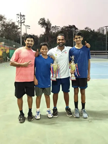 The players with their coaches after the U-14 doubles final.