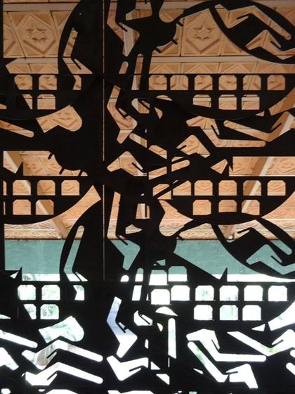 A close-up of the railing details at LMW Headquarters, featuring motifs of humans and animals designed by Manjit Bawa. This integration of narrative art into functional elements enriches the architectural experience.