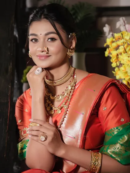 A classic Maharashtrian bridal look, captured from our student portfolio shoot. This image showcases the complete look, from the soft, blended makeup to the traditional jewelry and radiant smile.