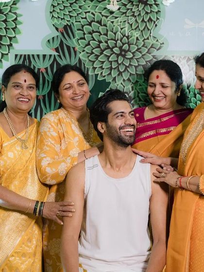 The matriarchs of the family showering the groom with blessings. Our decor honors these traditions by providing a respectful and beautiful setting.