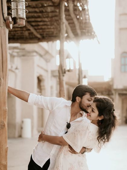 A romantic embrace with the sun setting over a rustic part of Dubai.