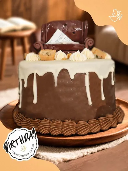 A cozy and comforting chocolate cake, topped with a fondant armchair and cookie pieces. This unique design is perfect for someone who loves to relax with a sweet treat.