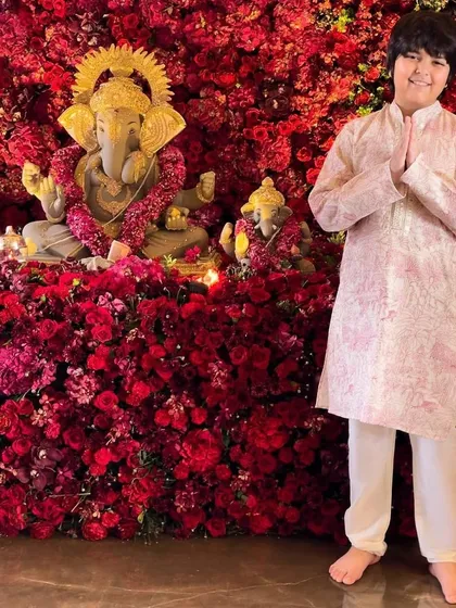 Another sweet moment from the Ratnani's Ganpati celebration, with the son dressed in a classic printed kurta.