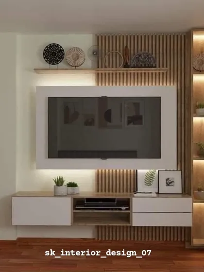 This TV unit design blends natural wood textures with white drawers and a vertical fluted panel. The illuminated display shelf provides a perfect spot for decor items.