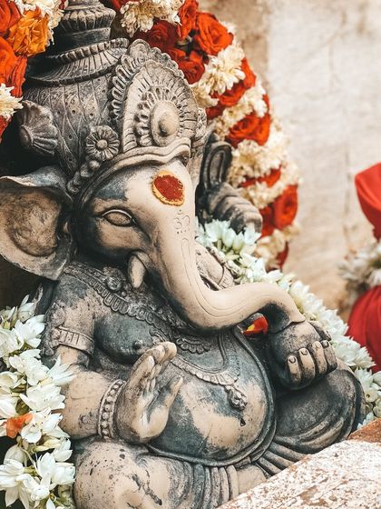 A statue of Lord Ganesha, the remover of obstacles, adorned with flowers. We begin all our important undertakings, including our teacher training, by seeking his blessings for a smooth and successful journey.