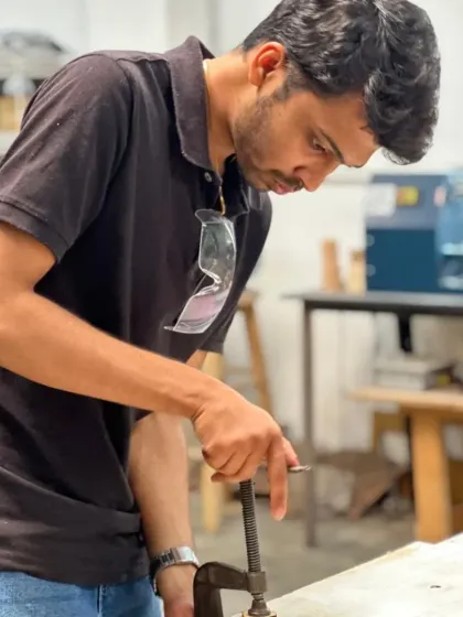 Clamping your piece securely is a crucial step for both safety and accuracy. Here, a participant gets ready to work on his project, ensuring everything is locked in place.