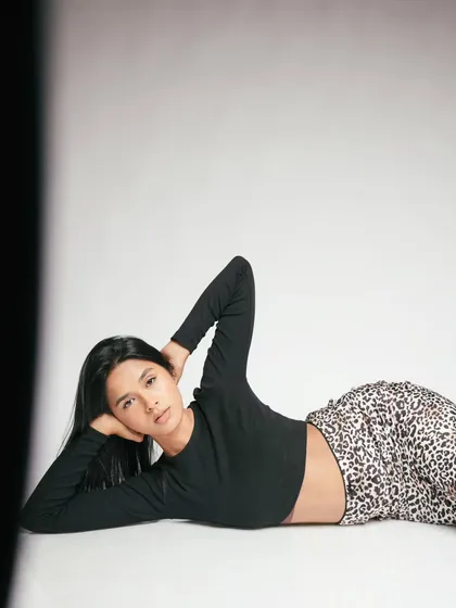 A relaxed, reclining pose that feels both elegant and confident. This is a great shot for showcasing a model's versatility.