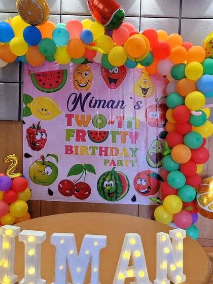 The "Two-tti Frutti" backdrop is perfect for a colorful and fun second birthday party.