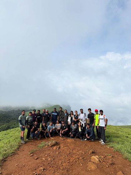 A group photo on the trail, with the vast meadows of Bandaje behind them.