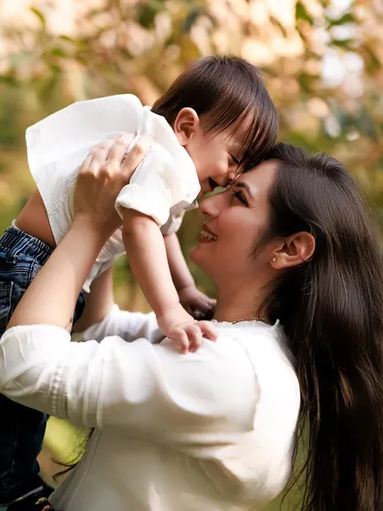The purest smiles are shared between a mother and her child. This joyful, playful moment from an outdoor family session is what candid photography is all about.