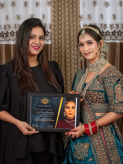 Me with one of my students and her final portfolio look. She mastered this intricate North Indian bridal style during her diploma course.